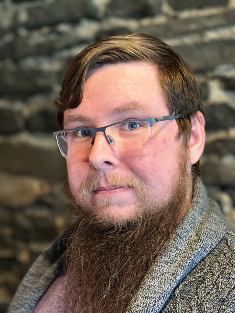 a man with a beard and glasses