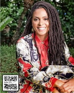 DeEtta Jones smiling with flowers in the hands